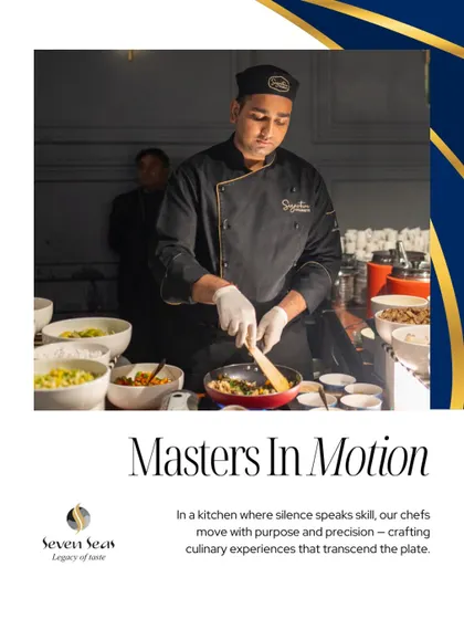 "Masters In Motion." A chef at a live cooking station, focused on his craft. The caption emphasizes the skill and purpose with which our team operates, turning cooking into a performance.