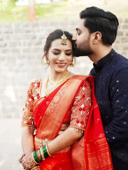 A tender forehead kiss, a classic romantic pose for an engagement photoshoot.