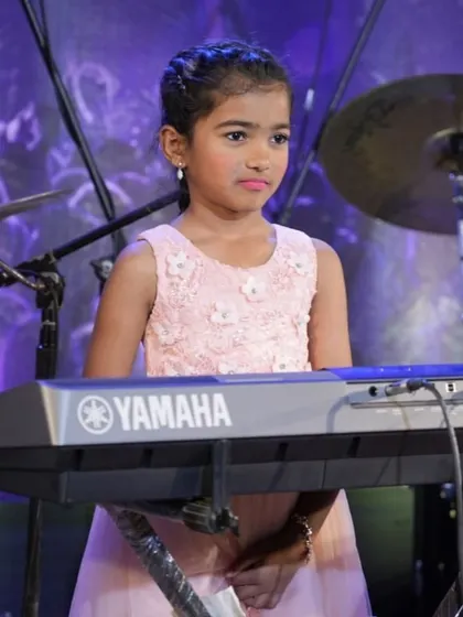 A collection of photos from our keyboard ensemble's performance of 'Chand Sifarish'. These shots capture the focus and joy of our young musicians and their teachers on stage.