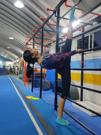 A beautiful demonstration of a needle scale stretch against the wall bars. This pose requires and builds extreme back and leg flexibility.