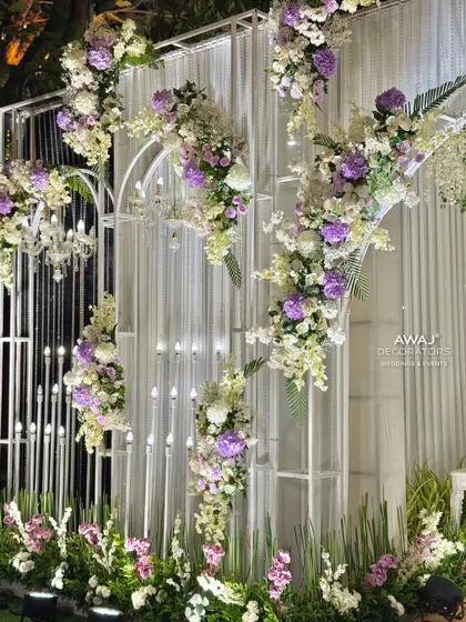 A close-up of the entrance wall, showing the beautiful floral arrangements and candle-like lighting fixtures.