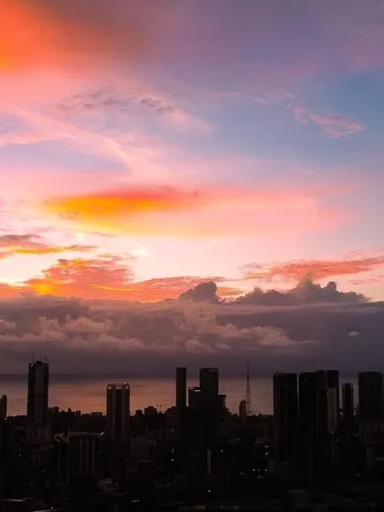 A stunning shot where the sky above Mumbai looks like a painting, with fiery orange clouds against a blue and pink canvas.