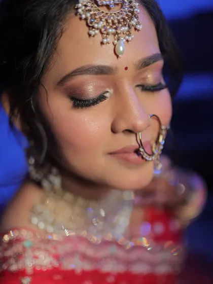 A detailed shot of the bride's eye makeup, featuring soft pink and brown tones.