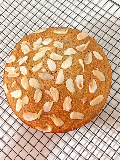 A top-down view of the gluten-free French Almond Cake, showcasing the beautiful texture and the generous topping of toasted almonds. It’s as delicious as it is beautiful.