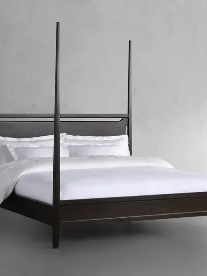 Our Brooklyn Bed, a modern take on the classic four-poster. Handcrafted by Indian artisans from solid ash wood, this bed is stained and sealed by hand to achieve a rich ebony color, with a clear lacquer topcoat for protection and a subtle sheen.