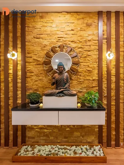This foyer creates a tranquil zen corner with a floating console against a stone-clad wall. The Buddha statue and pebble bed below enhance the peaceful and welcoming atmosphere.