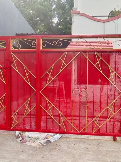 This main gate was given a bold new look with a vibrant red enamel paint, accented with gold details. Our enamel painting service is ideal for metal gates and grills, providing a tough, weather-resistant finish.