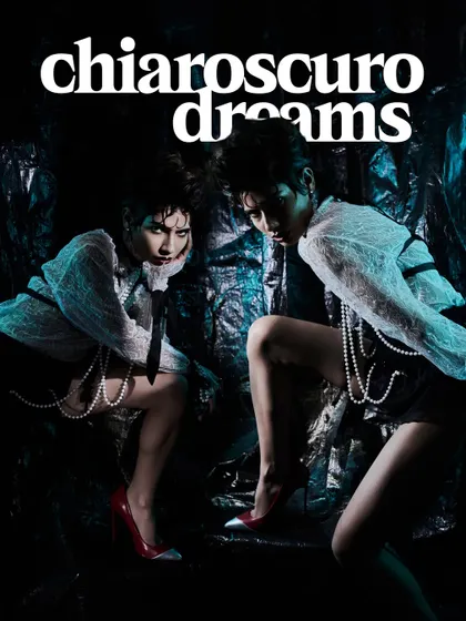 A double-trouble pose from "Chiaroscuro Dreams," with two models in a tight, confrontational composition.