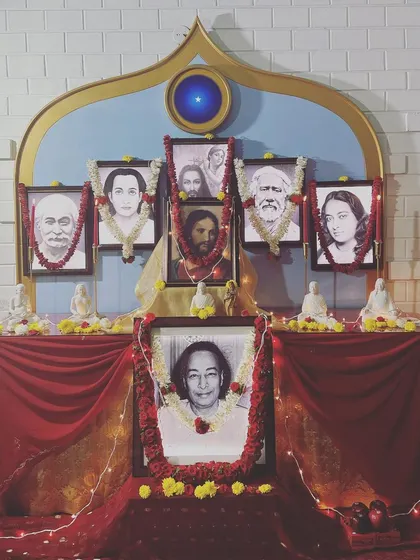 The altar decorated for the birth anniversary of Paramhansa Yogananda. The portraits of the six masters of our lineage are always present, reminding us of the unbroken chain of grace.