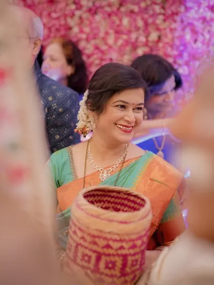 A mother's proud and happy smile, captured candidly as she watches the wedding ceremony. These are the moments that matter.