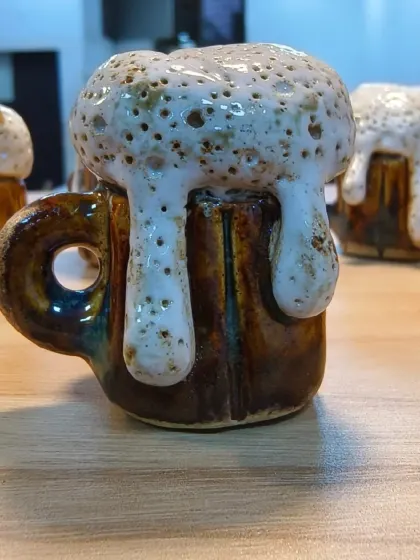 The full view of the tiny, handcrafted beer mug. This piece, made by our student Sejal, showcases exceptional skill in both sculpting and glazing.