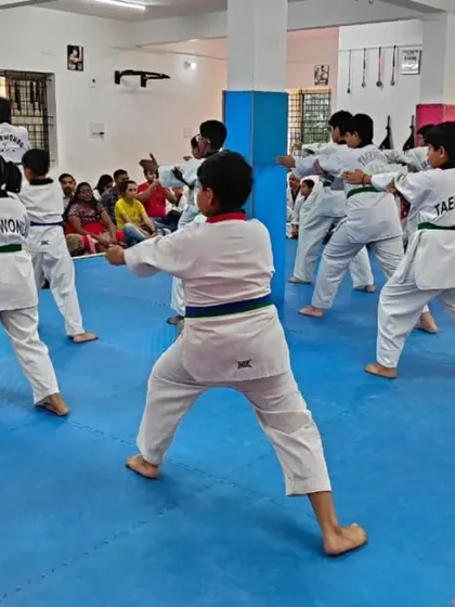 A class of green belts practicing their forms.