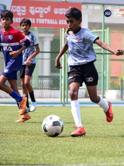 A young athlete dribbles past a defender, showcasing the confidence and technical ability fostered in our academy.