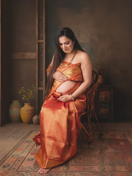 A beautiful studio portrait from my maternity shoot, sitting and connecting with my baby bump.