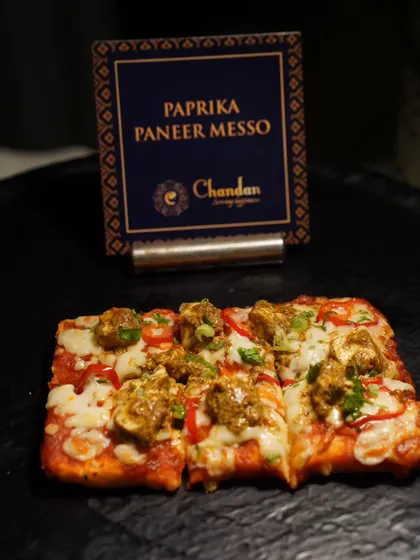 Paprika Paneer Messo, a fusion pizza-like flatbread topped with spicy paneer tikka. It's a great example of how I blend Indian flavors with global concepts.