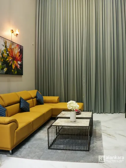 A bold statement in a modern living room. This custom L-shaped sofa in vibrant yellow is paired with industrial-style nested coffee tables and floor-to-ceiling curtains, showcasing my ability to work with dynamic color palettes.