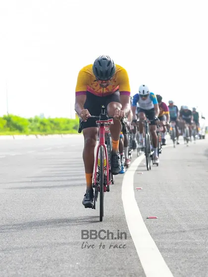 A rider from the masters category leads the peloton, setting a strong pace for the group.