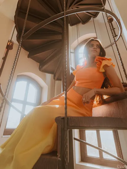 A stunning, fashion-inspired portrait of the bride-to-be on a spiral staircase, with sunlight streaming through the windows.