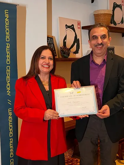 A winner receives his certificate of achievement at the Wingword award ceremony.