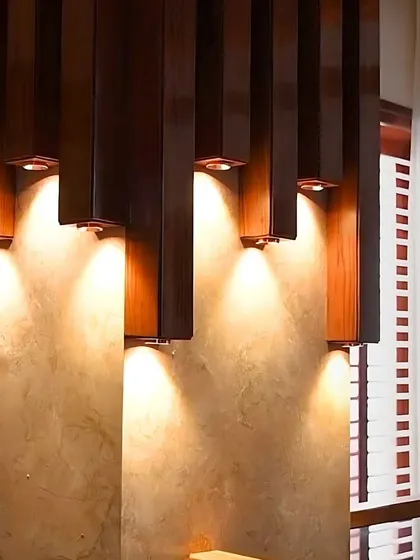 A close-up of the unique wooden pillar lights, each individually automated to create a custom lighting sculpture.
