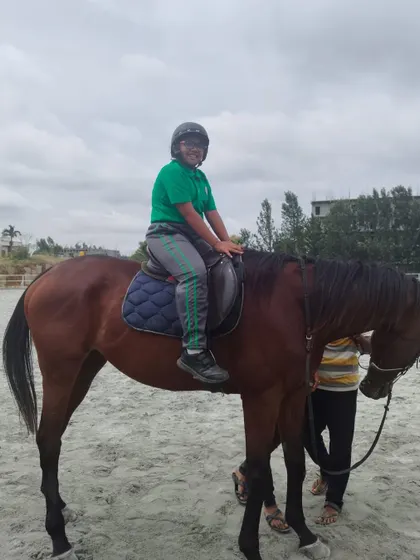 Another student enjoys his time at the stables, learning patience, discipline, and empathy through caring for and riding the horses.