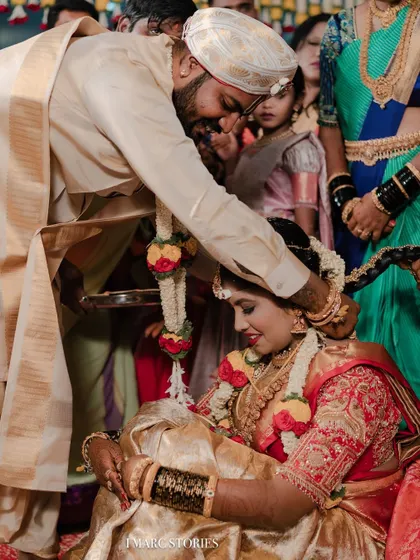 A beautiful moment from the wedding ceremony, showing the intricate details of the bride's custom blouse.