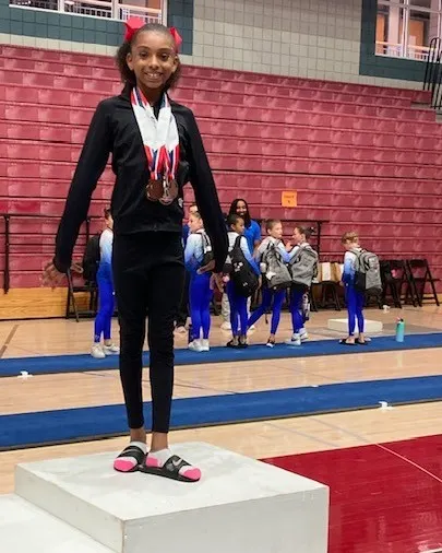 We have a State Champion on Vault! Riley proudly stands on the podium after winning first place at the Development Program Texas State Meet.
