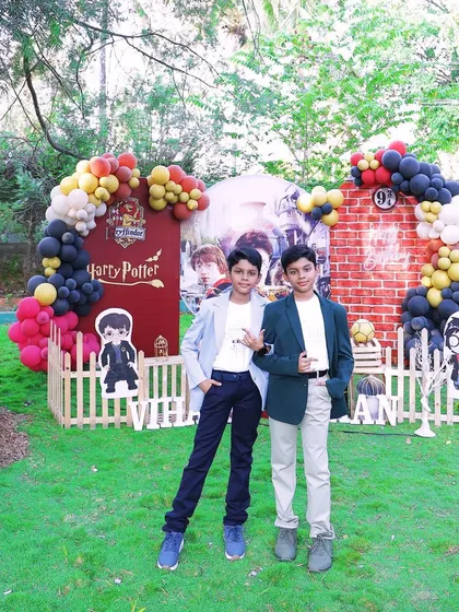 The birthday boys looking cool in front of their outdoor Harry Potter party decor. Our setups provide a fantastic backdrop for memorable photos.