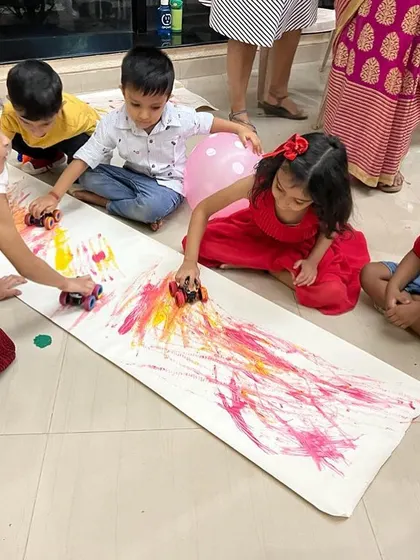 Process art is all about the experience, not the final picture. This car track painting activity is always a huge hit. It’s a fun, large-scale way for kids to explore color mixing and movement.