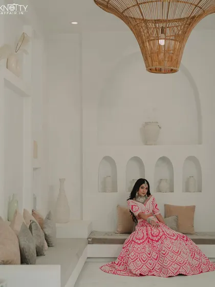 A serene portrait of the bride seated in a beautifully designed, Santorini-inspired space. We utilize unique locations to create stunning photos.