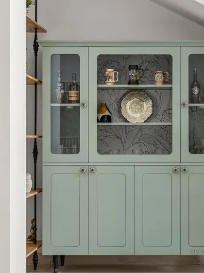 A closer look at the sage green cabinet, revealing the beautiful wallpaper lining inside. It’s these hidden details that make a piece truly special.