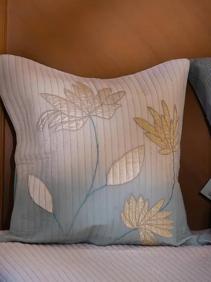 Feel the gentle caress of velvet and the serene charm of lotus embroidery with this cushion. The gradient of color from cream to soft teal adds a unique, artistic touch to the floral design.