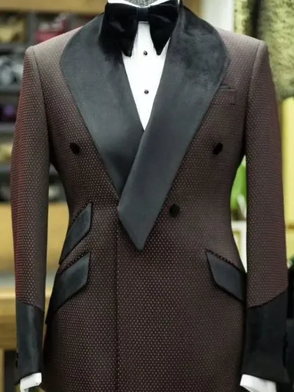 A double-breasted tuxedo in a brown textured fabric with black velvet accents. A very unique and luxurious piece.