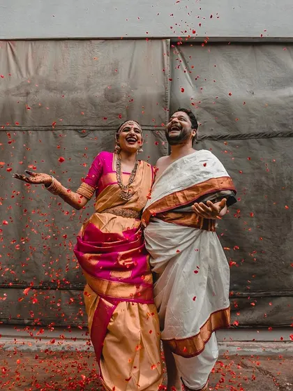 A shower of petals rains down on this laughing couple. This shot is full of pure, unadulterated joy and celebration.