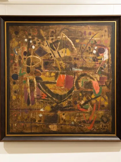 'Untitled (Brown)' from 1990 by Achutan Kudallur. In this composition, deep oranges and gold interlock like a labyrinth of memories. Kudallur’s brushwork builds a sense of structured chaos, drawing the viewer into an intricate dance of form and emotion.