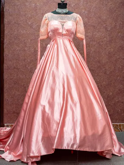 A princess-style peach ball gown with delicate lace sleeves, creating a fairy-tale look.