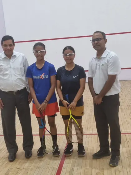 Standing with players and officials inside the court. We ensure our tournaments are refereed professionally to maintain a high standard of play.
