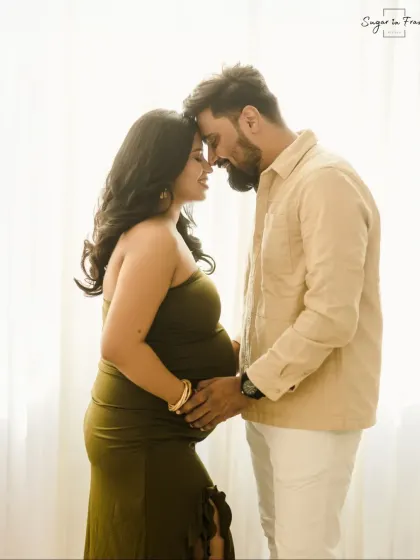 A beautifully backlit silhouette of an expecting couple, highlighting the baby bump. This artistic shot creates a feeling of intimacy and timeless love.
