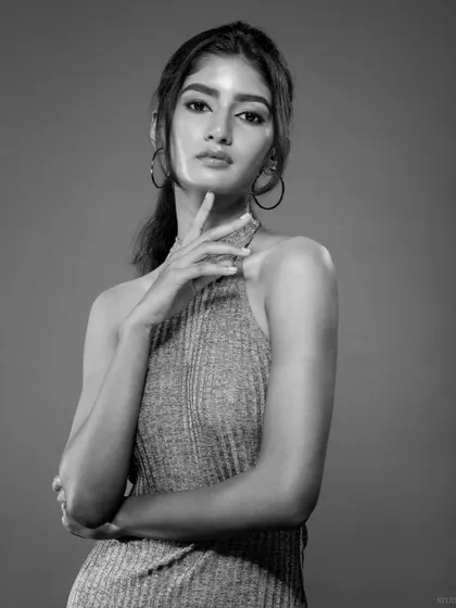 A classic black and white headshot, perfect for a model's comp card. The lighting is clean and focused, highlighting the model's features.