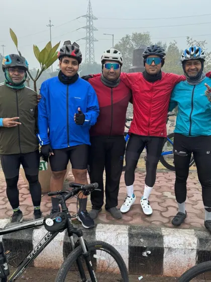 The team posing on a chilly morning. We ride in all weather, and our bond keeps us warm.