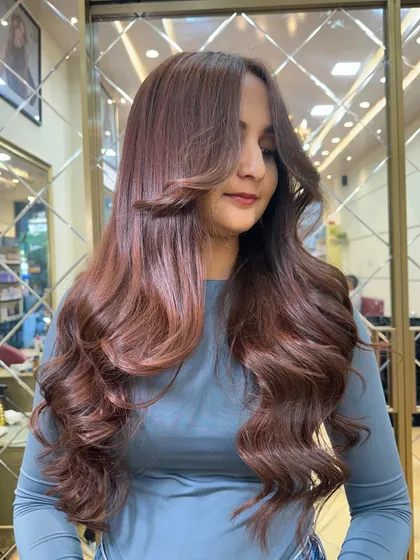 A beautiful shot of our Mocha Mousse global color, styled with soft, face-framing waves.