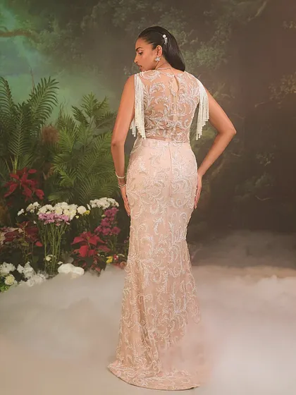 A view of the Nuray Gown's back, where the intricate embroidery continues across a sheer panel, offering a look that is as detailed from the back as it is from the front.
