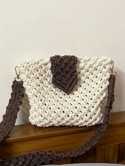 A lovely shot of the two-tone boho sling bag. The contrast between the off-white body and the dark brown strap and flap makes it really stand out.