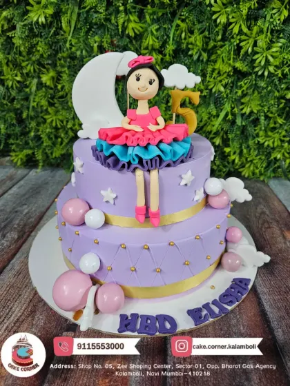 A beautiful two-tier doll cake in purple, celebrating a 5th birthday. The details on the doll's dress and the starry theme make it a magical choice.