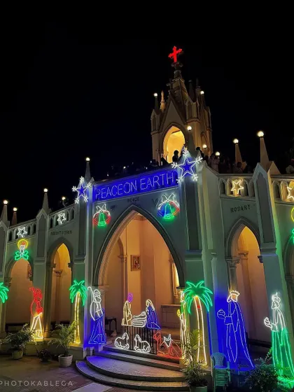 A nativity scene and other festive neon light decorations adorn the entrance of Mount Mary Church, creating a magical Christmas atmosphere.