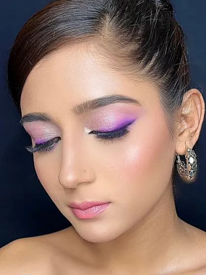 A playful look with a purple winged liner and shimmery lilac on the lids.