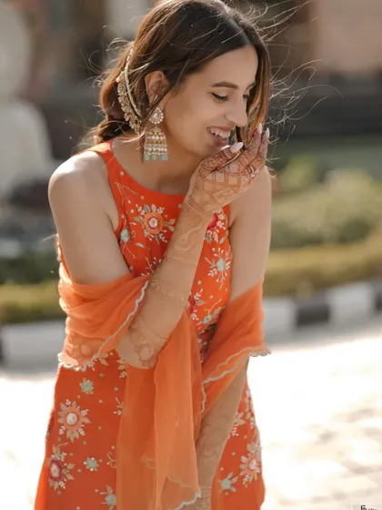 A candid shot of the bride's laughter during her Mehndi ceremony.