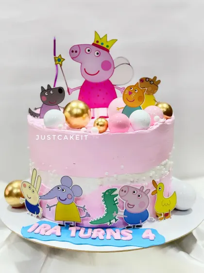 A fondant-free Peppa Pig cake. This design uses printed toppers and colorful buttercream to create a fun and playful scene.