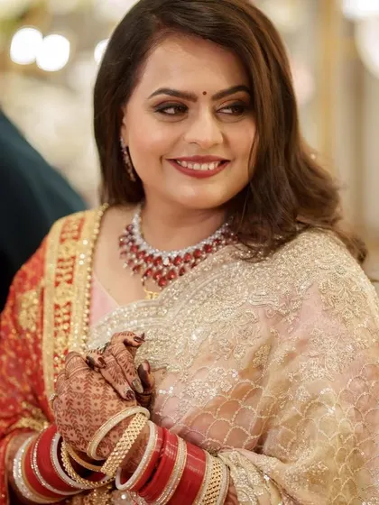 A portrait of the bride at her reception. The bold lip and smokey eyes create a timelessly glamorous look that is perfect for an evening celebration.