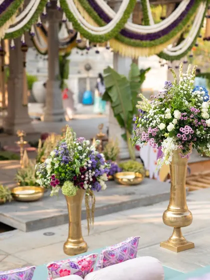 A beautiful floral arrangement in a brass vase, part of the traditional Muhurtham decor.